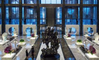 The lobby and main room of a spacious building offer various scenic views through its windows at Nuo Hotel Beijing