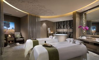 A spacious room with multiple beds and a scenic view, divided by a partition in the center at Sofitel Macau at Sofitel Macau at Ponte 16
