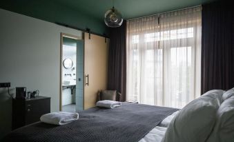 a hotel room with two beds , one on the left and one on the right side of the room at Mr Lewis Haarlem