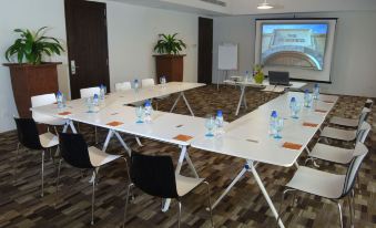 a conference room set up for a meeting , with chairs arranged in a semicircle around a long table at The Fortress Resort & Spa