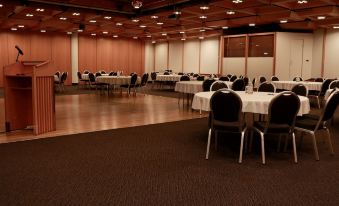 a large banquet hall with multiple tables and chairs arranged for a formal event , possibly a wedding reception at Hotel Selfoss