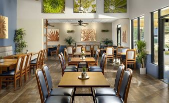 a dining room with several tables and chairs arranged for a group of people to enjoy a meal together at Hyatt Vacation Club at the Welk, San Diego