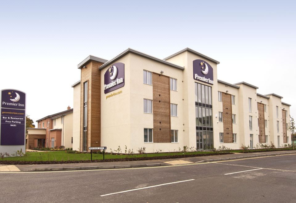 "a large white building with multiple signs that read "" premier inn "" and "" premier inn ""." at Premier Inn Burgess Hill