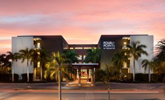 "a large building with a sign that reads "" four points by sheraton "" prominently displayed on the front of the building" at Four Points by Sheraton Puntacana Village