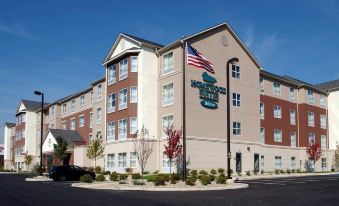 "a holiday inn express hotel with a large american flag and the word "" holiday inn "" displayed on it" at Homewood Suites by Hilton Bloomington