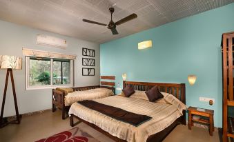 a room with two beds , one on the left side and the other on the right side of the room at Jungle Hut