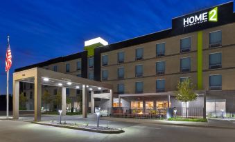 "a large hotel building with a sign that reads "" hotel "" prominently displayed on the front of the building" at Home2 Suites by Hilton Battle Creek