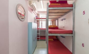 The bedroom is equipped with bunk beds and an overhead storage area in the middle at Check Inn HK