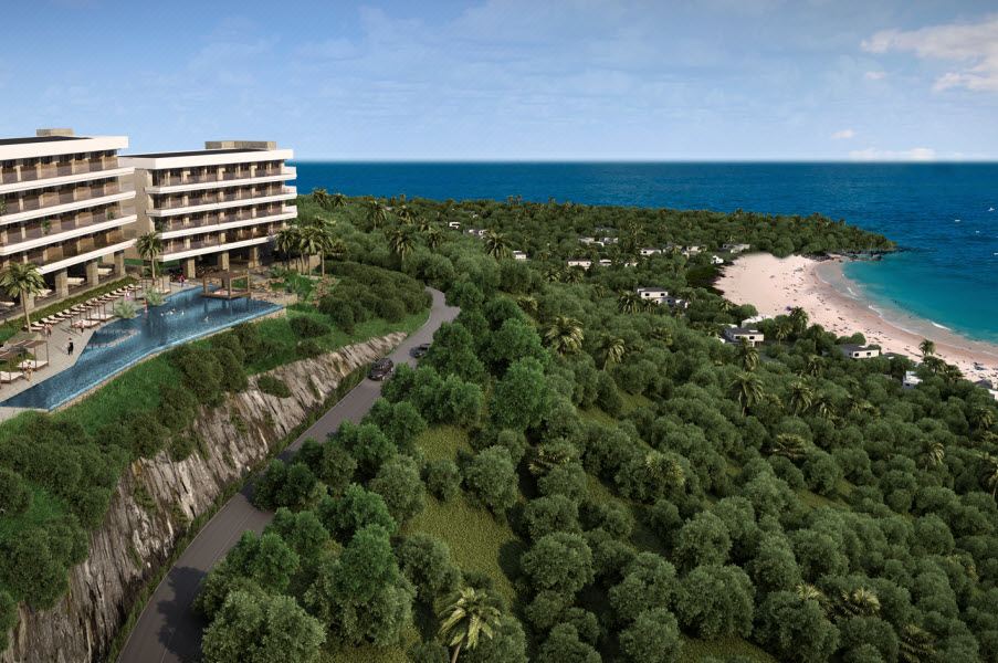 an aerial view of a resort with a large swimming pool surrounded by lush greenery and a beach in the background at Wyndham Tamarindo