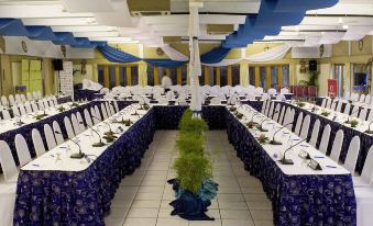 a long dining table set up for a formal event , with several chairs arranged around it at Novotel Suva Lami Bay