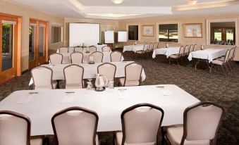 a large conference room with multiple tables and chairs arranged for a meeting or event at Sycuan Golf Resort