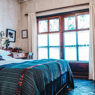 The Piano Room Secret Garden Entrance Through the Piano Bar, Queen Bed & Fountain Meson Panza Verde Promo Code