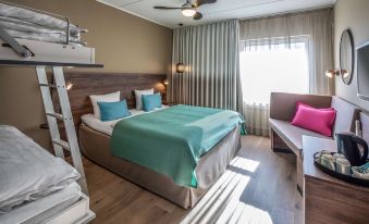 a modern hotel room with wooden floors , white curtains , and blue bedding on the bed at Scandic the Reef