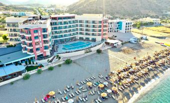 a large hotel with a pool and beach area is shown from an aerial view at Konstantinos Palace