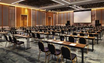 a large conference room filled with rows of chairs and tables , ready for a meeting or event at Movenpick Resort Cam Ranh