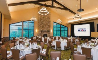 a large banquet hall with multiple tables and chairs set up for a formal event at Camelback Lodge & Aquatopia Indoor Waterpark