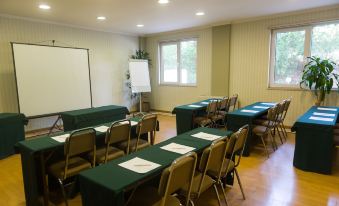 a conference room with several rows of tables and chairs , each set up for a meeting at Amazonia Jamor Hotel