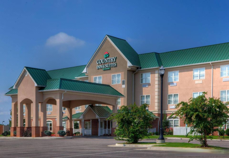 "a large hotel building with a green roof and the name "" country inns & suites "" prominently displayed" at Country Inn & Suites by Radisson, Emporia, VA