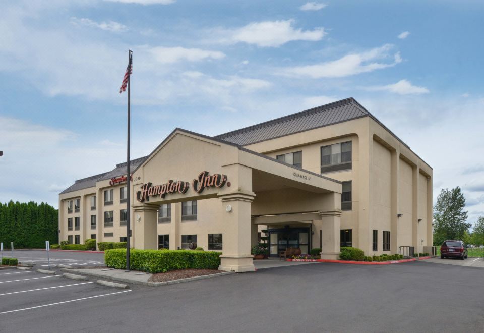 "a large , beige - colored hotel building with a sign that reads "" hampton inn "" prominently displayed on the front" at Hampton Inn Portland East