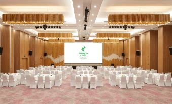 a ballroom with tables and chairs arranged for an event at Holiday Inn & Suites Saigon Airport