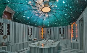 a large dining room with a ceiling covered in a starry sky pattern , creating a unique and captivating atmosphere at Kapadokya Hill Hotel & Spa (12+)