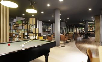 a billiards room with a pool table , couches , and chairs arranged in a cozy atmosphere at Mercure HAN Sur Lesse