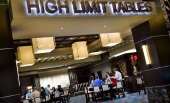 "a modern restaurant with high - end dining tables , people sitting at the bar , and a large sign reading "" high limit table "" above the" at Pala Casino Spa and Resort
