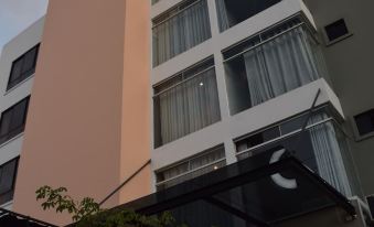 a modern building with a black and white logo on the front , situated in an urban environment at Hotel G