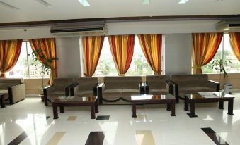 a large , empty living room with multiple couches and chairs arranged in a sitting area at Richmond Hotel Sylhet