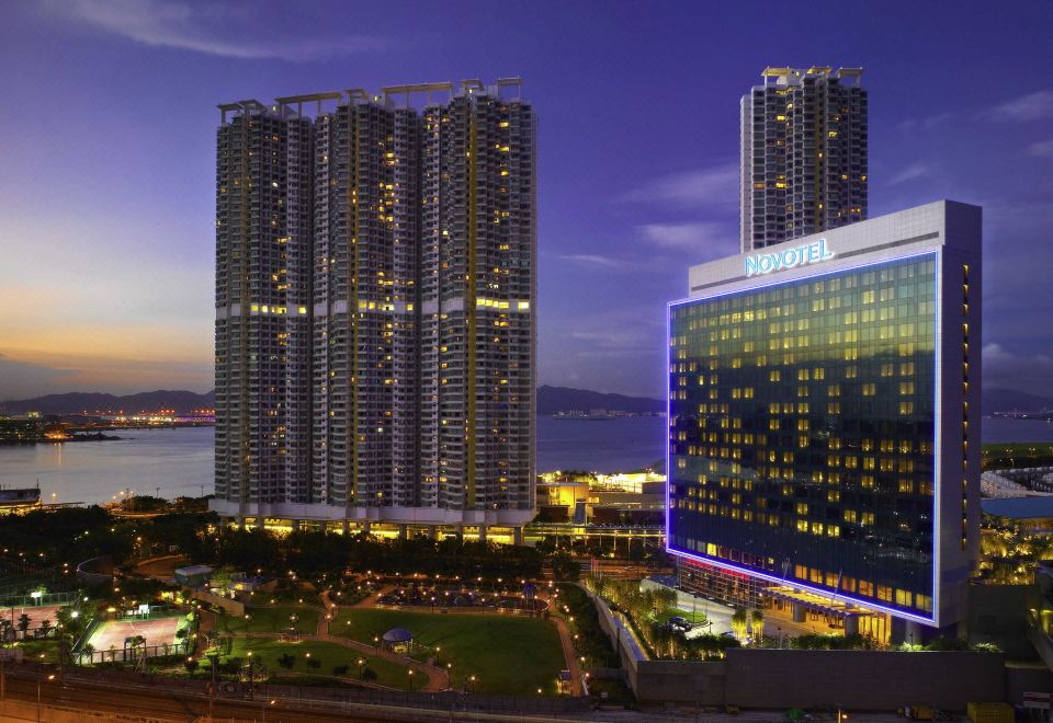 The hotel offers a stunning nighttime view of skyscrapers and other buildings at Novotel Citygate Hong Kong