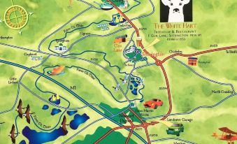 a map of a park with various attractions and attractions listed , along with a deer head emblem at The White Hart