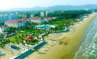aerial view of a beautiful beach resort with a swimming pool , palm trees , and a sandy beach at Hai Tien Plaza Hotel