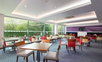 a large dining room with multiple tables and chairs arranged for a group of people to enjoy a meal together at Holiday Inn Express Burnley M65, Jct.10