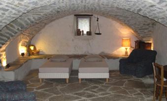 a cozy living room with two couches and a chair arranged in a cave - like setting at La Bergerie
