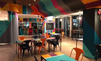 a brightly colored restaurant with colorful tables and chairs , creating a vibrant and inviting atmosphere at Lansdowne Hotel