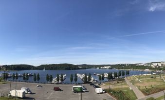 a panoramic view of a large body of water , possibly a lake or a river , with boats docked in the harbor at The Harbour Apartments