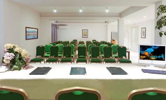 a conference room set up for a meeting , with chairs arranged in rows and a table in the center at Boutique Hotel Torre di Cala Piccola