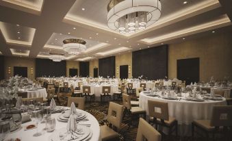 a large banquet hall with multiple tables set up for a formal event , possibly a wedding reception at DoubleTree by Hilton Reading