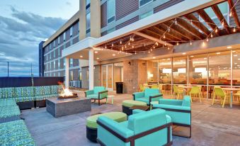 an outdoor seating area at a hotel , with several chairs and a fire pit at Home2 Suites by Hilton Helena