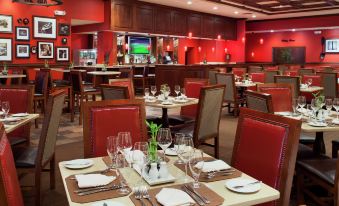 a large dining room with multiple tables and chairs arranged for a group of people to enjoy a meal at DoubleTree by Hilton Hotel Cincinnati Airport