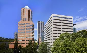 a city skyline with tall buildings and skyscrapers , including a white and orange one being taller at Portland Marriott Downtown Waterfront