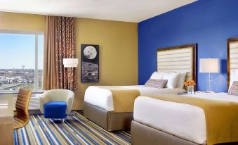 a hotel room with two beds , one on the left side of the room and the other on the right at The Moonrise Hotel