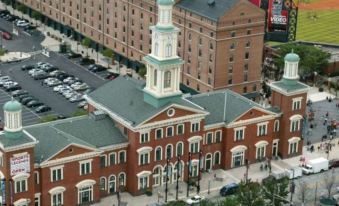 an aerial view of a city street with a red brick building and a tall clock tower at Courtyard Baltimore Hunt Valley
