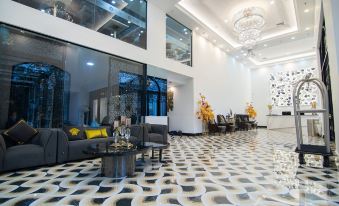 a modern living room with black and white tiled flooring , large windows , and a chandelier at SureStay Hotel by Best Western Vientiane