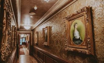 a hallway with two paintings hanging on the wall , creating a grand and elegant atmosphere at Prince of Wales