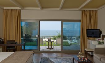 a room with a large window overlooking the ocean , creating a serene and tranquil atmosphere at Le Royal Hotel - Beirut