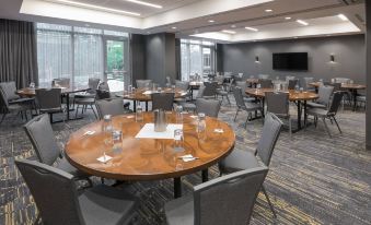 a large , modern conference room with multiple round tables and chairs arranged for meetings or events at Residence Inn Halifax Dartmouth