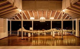 a wooden pavilion with white lights and chandeliers , giving it an elegant and inviting atmosphere at Residences at Nonsuch Bay Antigua - Room Only - Self Catering