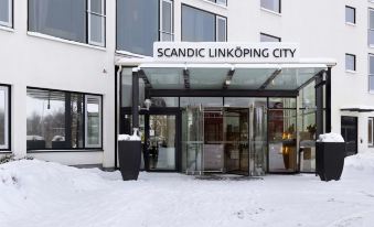 "a snowy entrance to a building with the words "" scandic linköping city "" above it" at Scandic Linkoping City