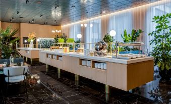 a modern , minimalist restaurant interior with large windows , marble floors , and a dining table with food items on it at NH Collection Antwerp Centre